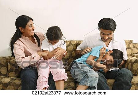 Family tickling on couch View Large Photo Image Stock Photo - Family tickling on couch. Fotosearch