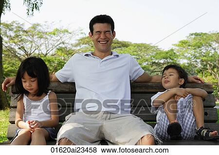 Father and children on park bench View Large Photo Image Stock Photo - Father and children on park bench. Fotosearch