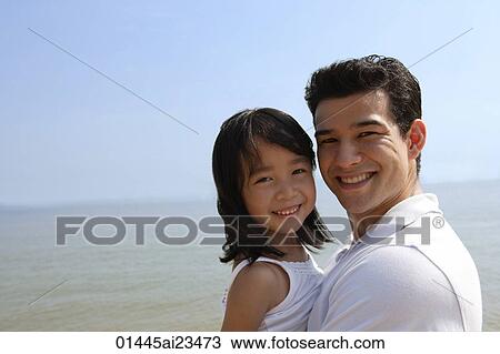Father and daughter at the beach, looking at camera View Large Photo Image Stock Image - Father and daughter at the beach, looking at camera. Fotosearch
