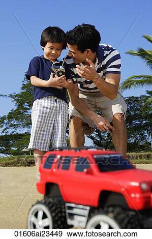 Father and son at the beach with remote controlled toy View Large Photo Image Stock Photo - Father and son at the beach with remote controlled toy. Fotosearch