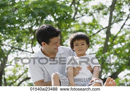 Father and son at the park View Large Photo Image Stock Photo - Father and son at the park. Fotosearch