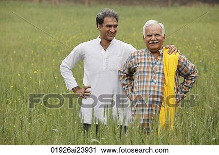Stock Image - father and son farmers in field. Fotosearch