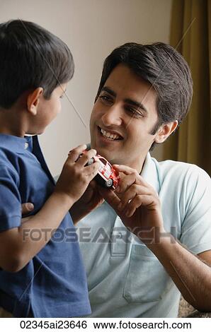 father and son holding red toy car View Large Photo Image Stock Photograph - father and son holding red toy car. Fotosearch