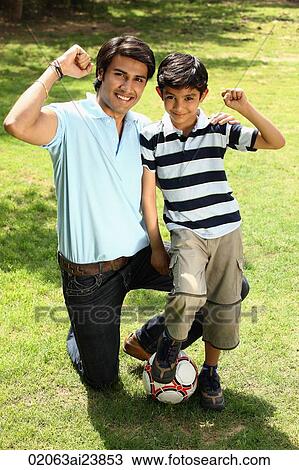 Father and son in park with ball View Large Photo Image Stock Image - Father and son in park with ball. Fotosearch