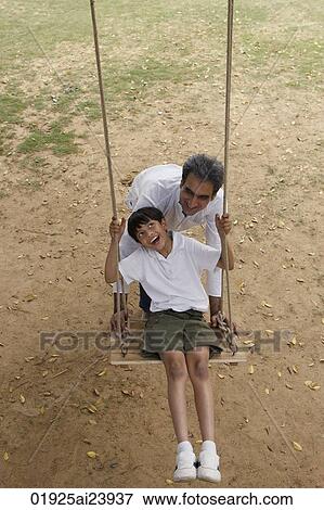 Stock Photo - father and son in swing. Fotosearch