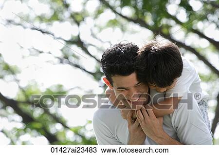 Father and son playing at the park View Large Photo Image Stock Image - Father and son playing at the park. Fotosearch