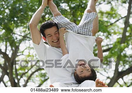 Stock Photo - Father and son playing at the park. Fotosearch