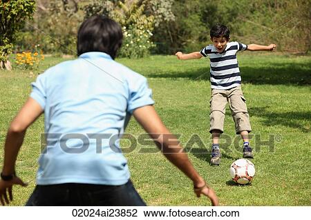 Father and son playing soccer View Large Photo Image Stock Image - Father and son playing soccer. Fotosearch