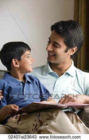 father and son smiling at each other, story book View Large Photo Image Stock Image - father and son smiling at each other, story book. Fotosearch