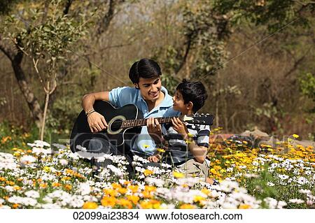 Father and son with guitar outside View Large Photo Image Picture - Father and son with guitar outside. Fotosearch
