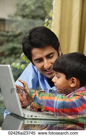 father and son work at laptop View Large Photo Image Stock Photography - father and son work at laptop. Fotosearch