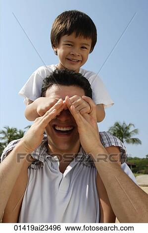 Father carrying son on his shoulders st the beach View Large Photo Image Stock Photograph - Father carrying son on his shoulders st the beach. Fotosearch