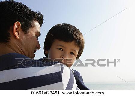 Father carrying son View Large Photo Image Stock Image - Father carrying son. Fotosearch