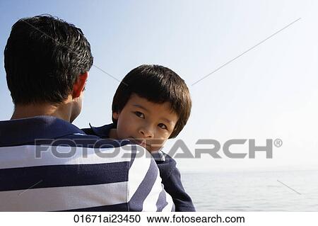 Stock Image - Father carrying son. Fotosearch