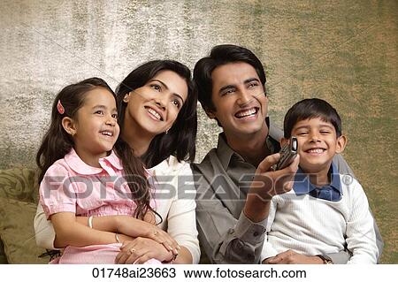 Stock Image - father holds phone up in family portrait. Fotosearch