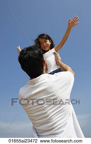 Stock Image - Father picking up daughter. Fotosearch