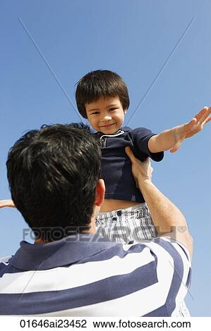 Stock Image - Father picking up son. Fotosearch