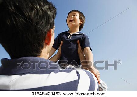 Father picking up son View Large Photo Image Stock Image - Father picking up son. Fotosearch