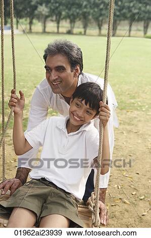 father with son on swing View Large Photo Image Stock Photo - father with son on swing. Fotosearch