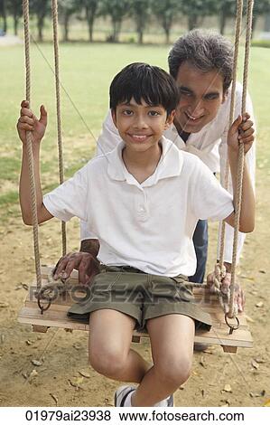 father with son on swing View Large Photo Image Stock Photo - father with son on swing. Fotosearch
