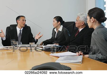 Stock Image - four business people in meeting. Fotosearch