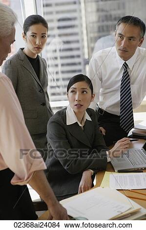 four business people talking View Large Photo Image Picture - four business people talking. Fotosearch