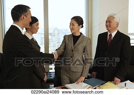 four business people, two shaking hands View Large Photo Image Stock Photo - four business people, two shaking hands. Fotosearch