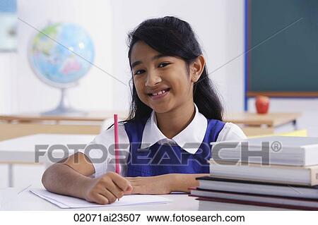girl at desk with red pencil and books (horizontal) View Large Photo Image Stock Photo - girl at desk with red pencil and books (horizontal). Fotosearch