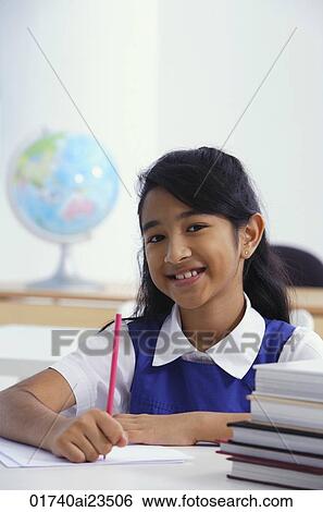girl at desk with red pencil (vertical) View Large Photo Image Stock Photograph - girl at desk with red pencil (vertical). Fotosearch