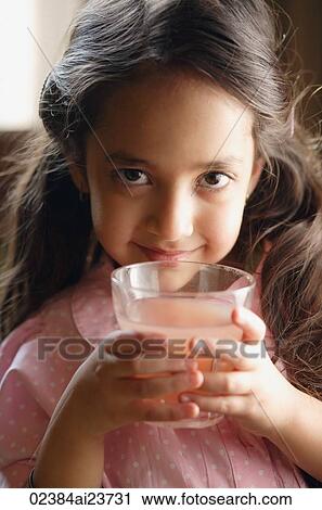 girl holding pink drink, looking at camera View Large Photo Image Stock Image - girl holding pink drink, looking at camera. Fotosearch