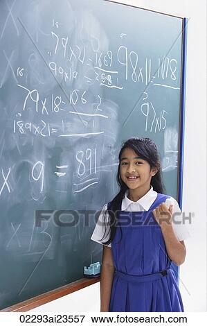 girl in front of chalkboard smiling View Large Photo Image Stock Photo - girl in front of chalkboard smiling. Fotosearch