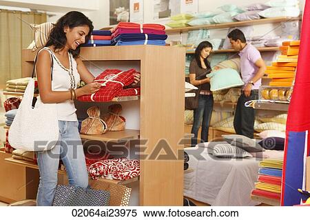 girl in store, couple in background View Large Photo Image Stock Photography - girl in store, couple in background. Fotosearch