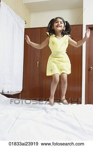 Girl jumping on bed View Large Photo Image Stock Photo - Girl jumping on bed. Fotosearch