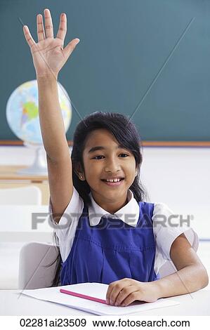 Stock Photo - girl raises hand in class. Fotosearch