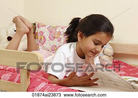 Girl reading book in bed View Large Photo Image Stock Image - Girl reading book in bed. Fotosearch