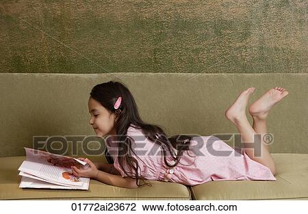 girl reading storybook on sofa, barefoot View Large Photo Image Stock Image - girl reading storybook on sofa, barefoot. Fotosearch