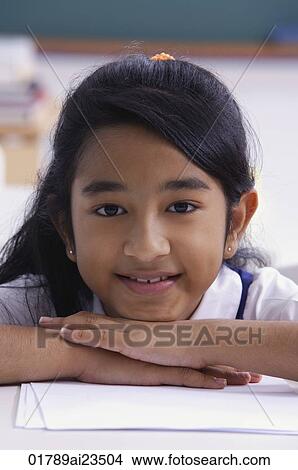 girl resting chin on folded hands View Large Photo Image Picture - girl resting chin on folded hands. Fotosearch