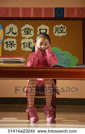 Girl sitting in class, looking at camera View Large Photo Image Stock Photography - Girl sitting in class, looking at camera. Fotosearch