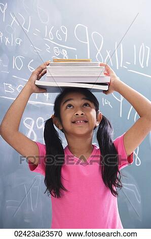 girl with books stacked on head, looking up (vertical) View Large Photo Image Stock Image - girl with books stacked on head, looking up (vertical). Fotosearch