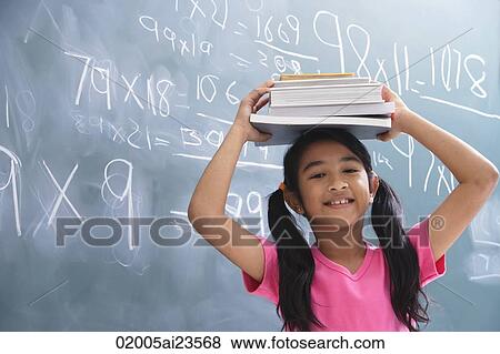 Stock Photo - girl with books stacked on head. Fotosearch