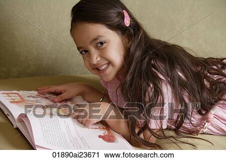 girl with story book smiling at camera View Large Photo Image Stock Image - girl with story book smiling at camera. Fotosearch