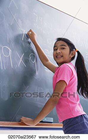 girl working at chalkboard, facing camera (vertical) View Large Photo Image Stock Photo - girl working at chalkboard, facing camera (vertical). Fotosearch