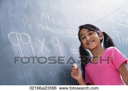 Stock Photograph - girl working at chalkboard, facing camera (horizontal). Fotosearch