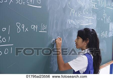 girl working at chalkboard (horizontal) View Large Photo Image Stock Photograph - girl working at chalkboard (horizontal). Fotosearch