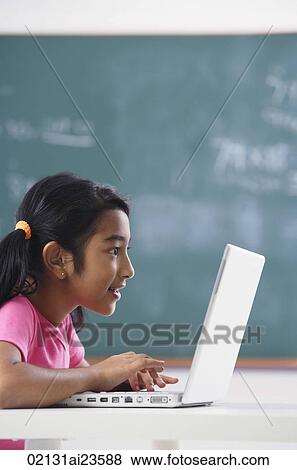 girl working at laptop (vertical) View Large Photo Image Stock Photo - girl working at laptop (vertical). Fotosearch