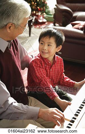 Grandfather and grandson playing piano View Large Photo Image Stock Image - Grandfather and grandson playing piano. Fotosearch