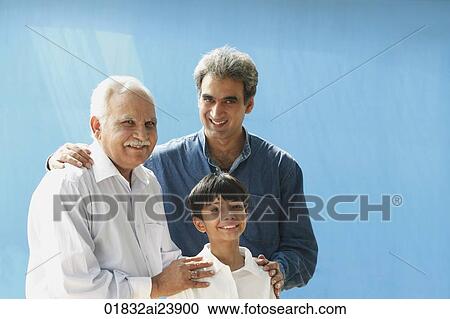 Stock Image - Grandfather, father, son smiling at camera. Fotosearch