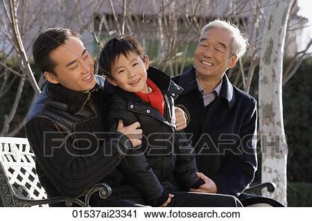 Stock Image - Grandfather, son and grandson in the park. Fotosearch