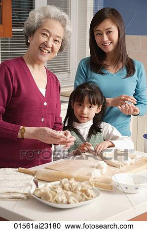 Grandmother, daughter and granddaughter making dumplings in the kitchen, looking at camera View Large Photo Image Stock Image - Grandmother, daughter and granddaughter making dumplings in the kitchen, looking at camera. Fotosearch