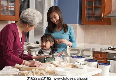 Grandmother, daughter and granddaughter making dumplings in the kitchen View Large Photo Image Stock Image - Grandmother, daughter and granddaughter making dumplings in the kitchen. Fotosearch